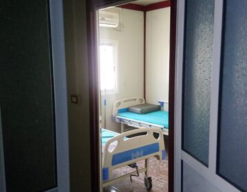 A view through the corridor into the patient room with two beds at the field hospital in al-Hol camp.